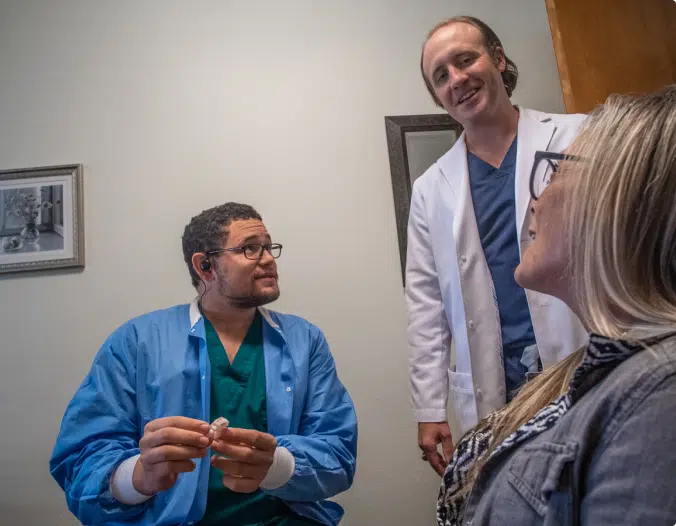 dental implant specialist with a patient discussing a smile makeover in fort worth, tx
